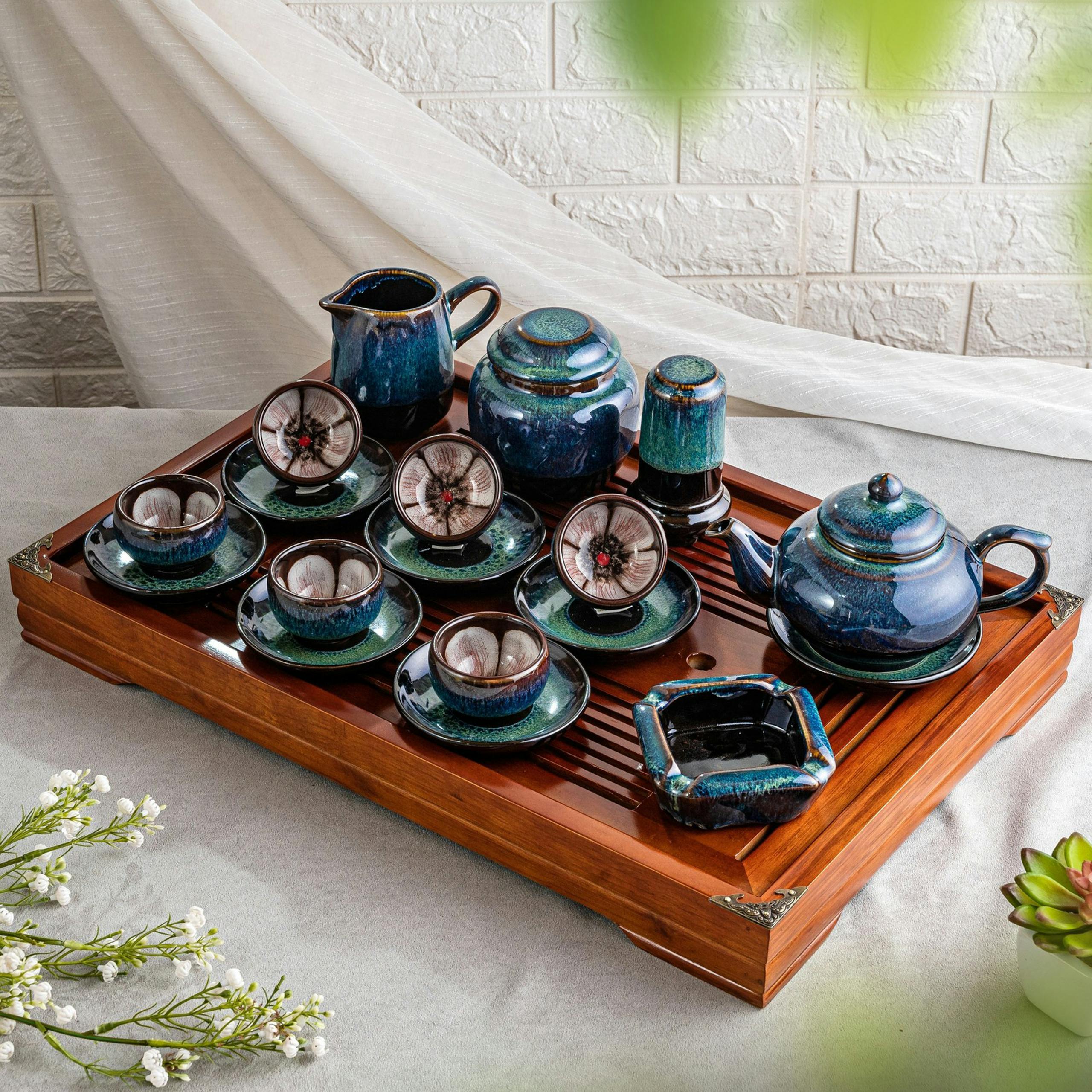 Elegant Vietnamese porcelain tea set displayed on a wooden tray, perfect for cultural celebrations.